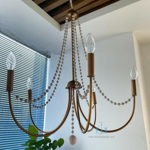 Gold And White 5 Light Mid-century Modern Chandelier With Wood Beads, Chain Pendant Installation, Candelabra Base Type, AC Power Source, 90-260V, available exclusively on Shahi Sajawat India, the world of home decor products.Best trendy home decor, living room, kitchen and bathroom decor ideas of 2023.