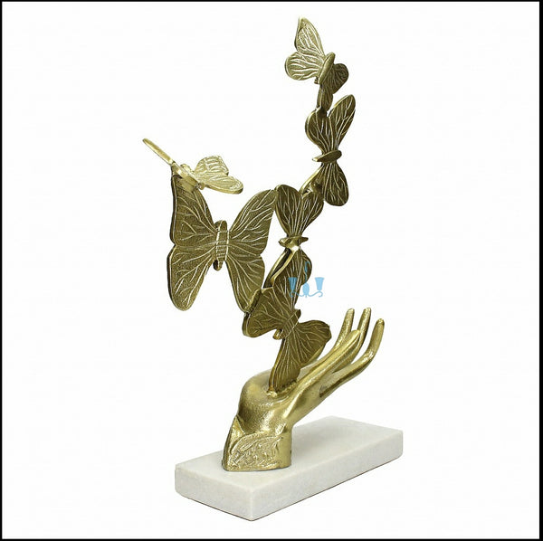 Gold Rising Butterfly From Open Hands Metal Table Top Handcrafted Sculpture (Figurine), Available exclusively on Shahi Sajawat India, the world of home decor products. Best trendy home decor, office decor, living room,table decor, kitchen and bathroom decor ideas of 2022.
