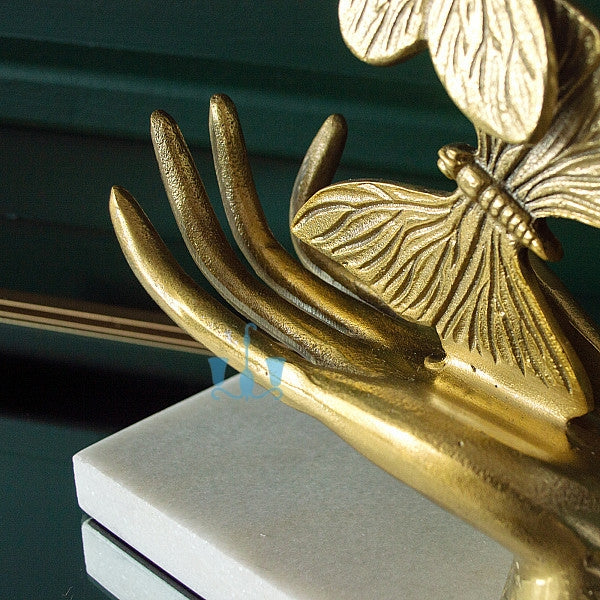 Gold Rising Butterfly From Open Hands Metal Table Top Handcrafted Sculpture (Figurine), Available exclusively on Shahi Sajawat India, the world of home decor products. Best trendy home decor, office decor, living room,table decor, kitchen and bathroom decor ideas of 2022.
